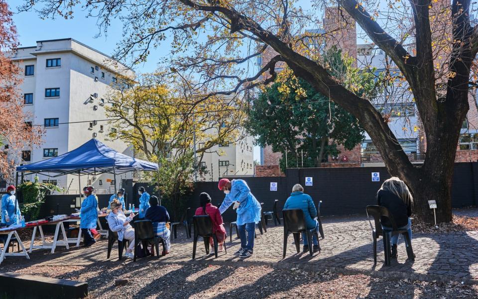 People wait to be swab tested at a Testaro Covid-19 testing site/laboratory in the Dunkeld suburb of Johannesburg, South Africa, on Thursday, July 1, 2021.  - Bloomberg