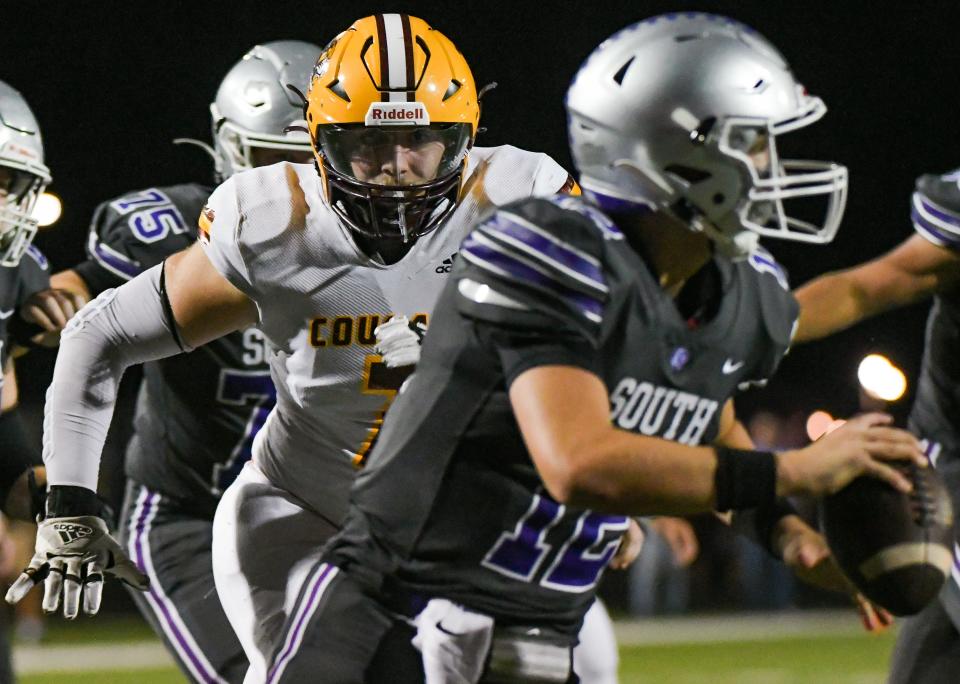 Bloomington North’s Grey Hostetler (7) looks to pressure Bloomington South’s Jarrin Alley (12) during the North-South football game at South on Friday, September 8, 2023.