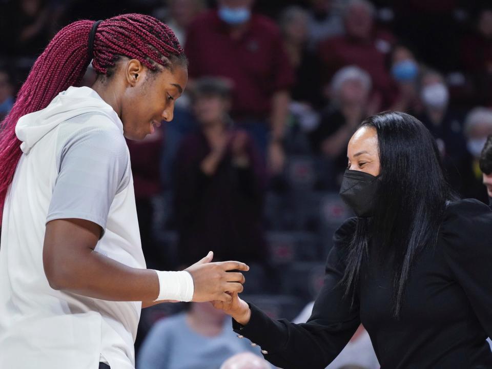 South Carolina All-American Aliyah Boston (left) shakes hands with Gamecocks head coach Dawn Staley.