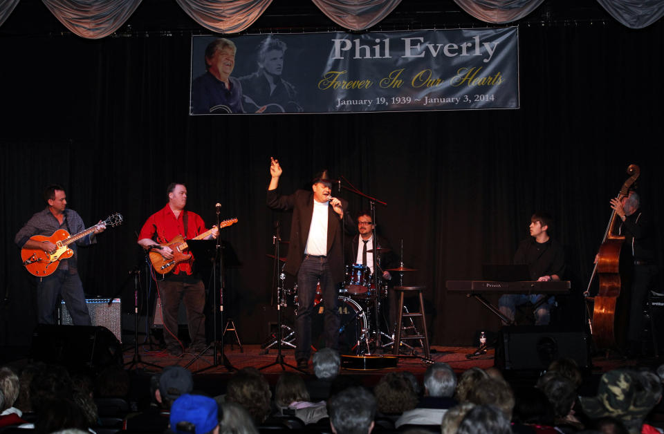 Country music artist Marty Brown, center, perform songs made famous by Phil and Don Everly of the The Everly Brothers at a memorial service for Phil Everly at the Merle Travis Music Center in Powderly, Ky, Saturday, Jan. 18, 2014. (AP Photo/John Sommers II)