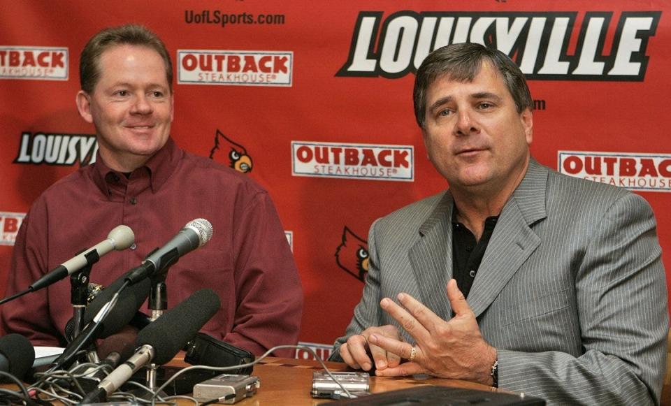 U of L coach Bobby Petrino, left, and athletic director Tom Jurich had reason to smile after accepting a bid to the Jan. 2 Gator Bowl.