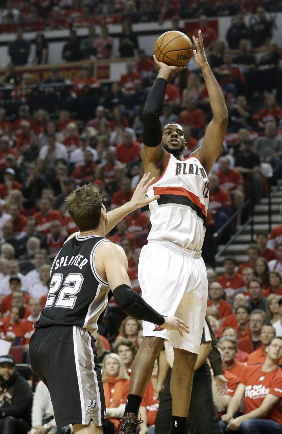 Portland Trail Blazers' LaMarcus Aldridge (12) shoots as San Antonio Spurs' Tiago Splitter (22) looks on in the first quarter during Game 3 of a Western Conference semifinal NBA basketball playoff series Saturday, May 10, 2014, in Portland, Ore. (AP Photo/Rick Bowmer)