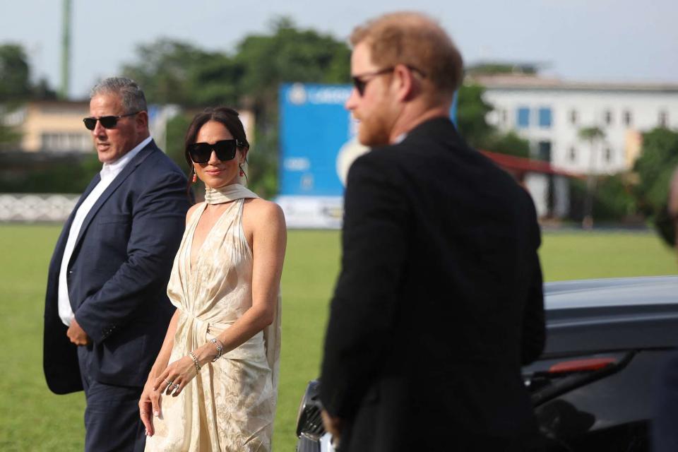 <p>KOLA SULAIMON/AFP via Getty</p> Meghan Markle and Prince Harry arrive at a charity polo club in Lagos on May 12, 2024