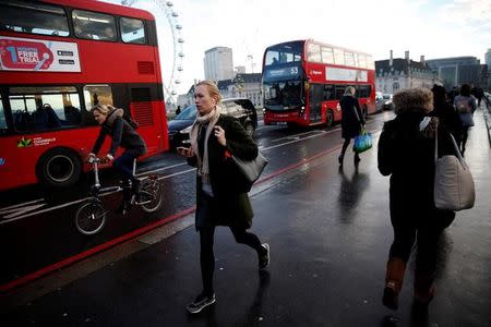 FILE PHOTO: People walk, cycle and ride buses accross Westminster Bridge on the second day of a train strike in London, Britain December 14, 2016. REUTERS/Neil Hall/File Photo