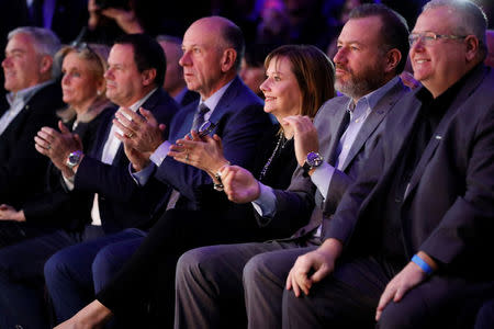 General Motors CEO Mary Barra (3rd R), with husband Tony Barra (4th R), applauds new Chevrolet trucks at the North American International Auto Show in Detroit, Michigan, U.S. January 13, 2018. REUTERS/Jonathan Ernst
