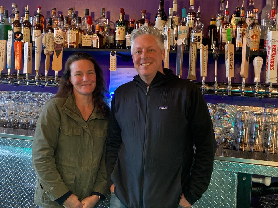 Beth and Chris Oleks, owners of Alfie's Wild Ride, stand behind the bar at the Stowe food/drink/entertainment establishment Nov. 8, 2021.
