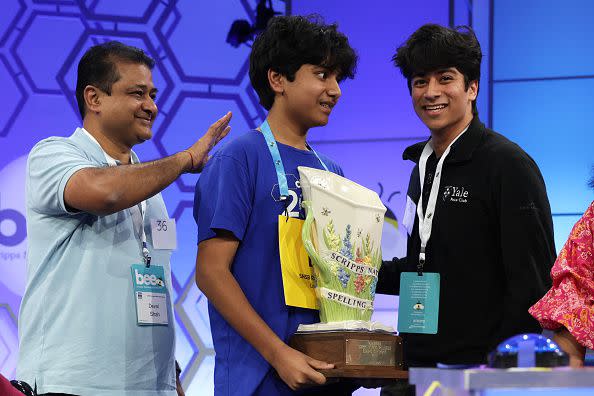 NATIONAL HARBOR, MARYLAND - JUNE 01:  Speller Dev Shah of Largo, Florida, celebrates with his father Deval Shah, and brother Neil Shah after he won the 2023 Scripps National Spelling Bee at Gaylord National Hotel and Convention Center on June 1, 2023 in National Harbor, Maryland. Shah correctly spelled the word 