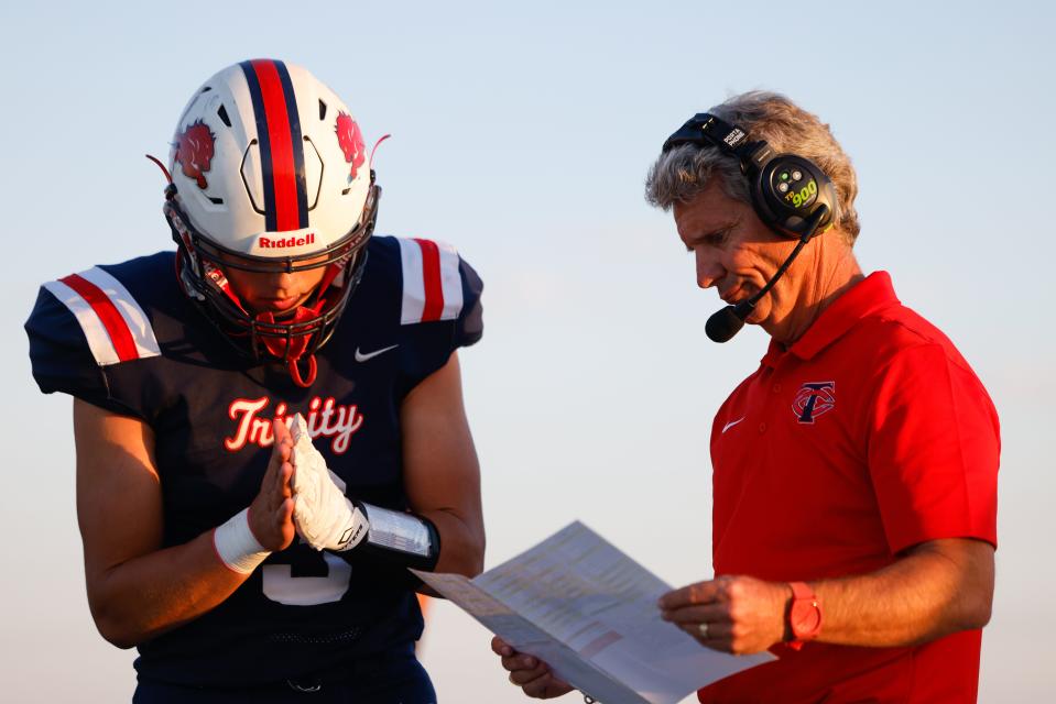 Trinity Christian coach Kevin Spiller talks to Eli Reeves (3) during a game against Denver City in a non-district game, Friday, Sept. 30, 2022, at Trinity Christian Athletic Complex.