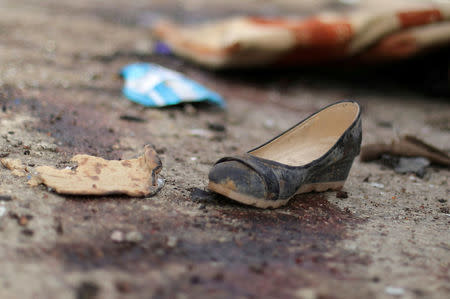 A shoe is seen near blood stains following a car bomb attack in Hasaka province, Syria, October 13, 2017. REUTERS/Rodi Said