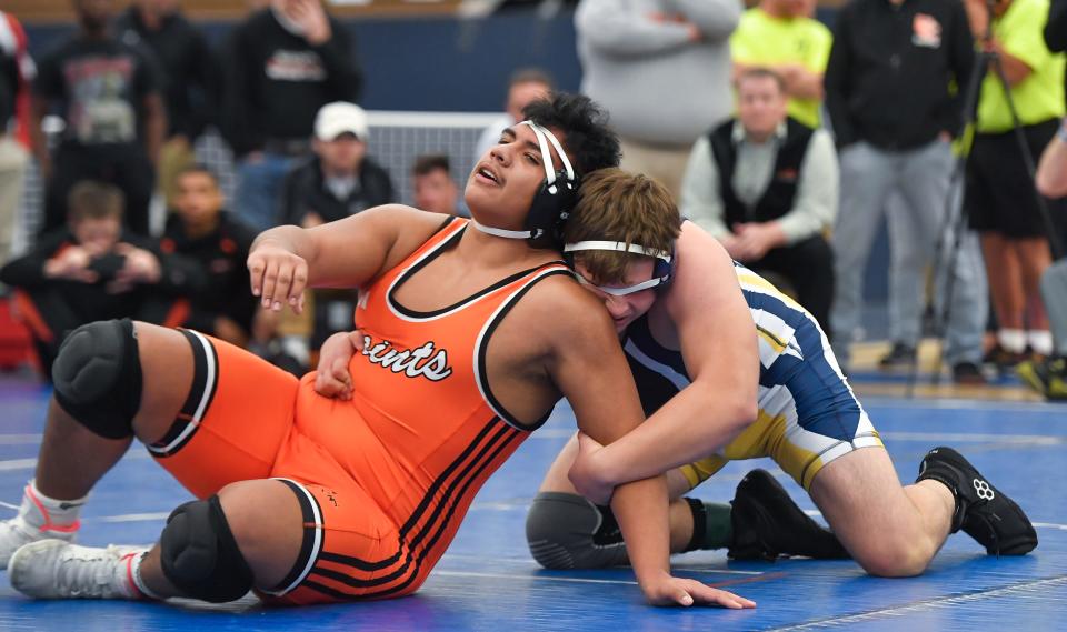 Churchville-Chili’s Gael Sanchez, left, wrestles Webster Thomas’ Anthony Cimino in the final of the 285-pound weight class during the Monroe County Wrestling Championships, Saturday, Dec. 16, 2023.