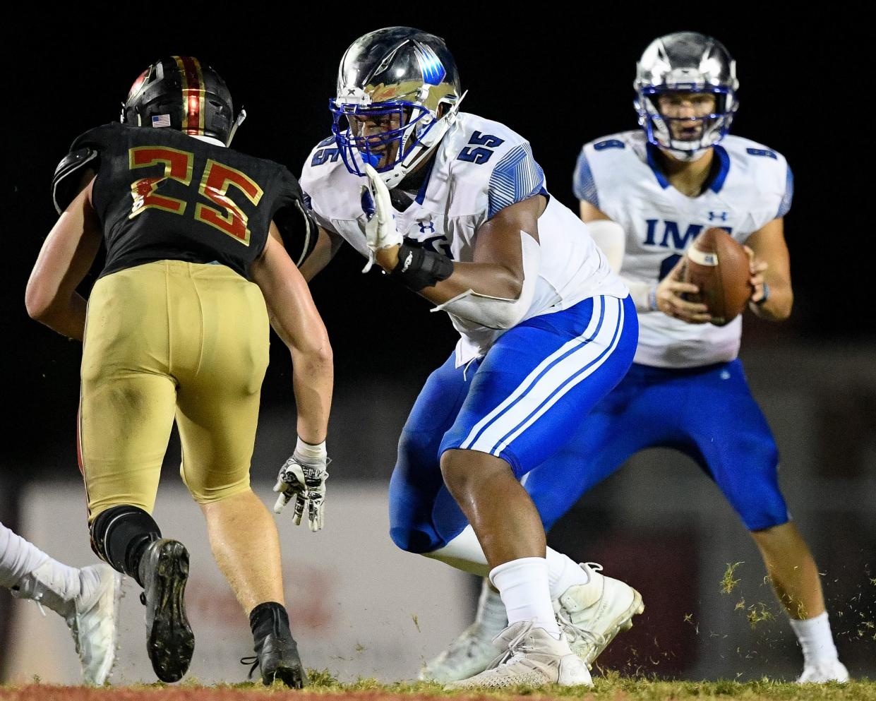 IMG Academy's JC Latham (55) defends against Ravenwood's Zack Maaske (25) during the second half at Ravenwood High School in Brentwood, Tenn., Friday, Sept. 25, 2020.