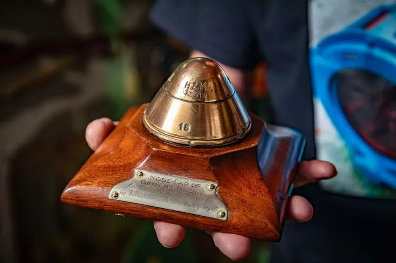 This is the nose-cap of a German Shell which has been presented on a wooden block which reads 'fired into the British Trenches at Vermelles, France, May 1915.' -Credit:SWNS