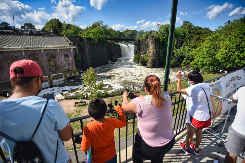 Visitors watch the Great Falls during the last day of the Great Falls Festival in Paterson on 09/06//21.