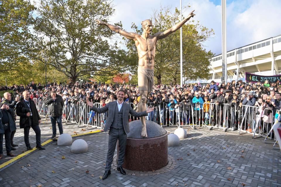 TOPSHOT - Sweden's biggest football star, Los Angeles Galaxy's forward Zlatan Ibrahimovic poses next to the 2,7 m bronze statue of him, after the unveiling ceremony on October 8, 2019 near the stadium where he made his professional debut in his hometown of Malmo in southern Sweden. (Photo by Johan NILSSON / TT News Agency / AFP) / Sweden OUT (Photo by JOHAN NILSSON/TT News Agency/AFP via Getty Images)