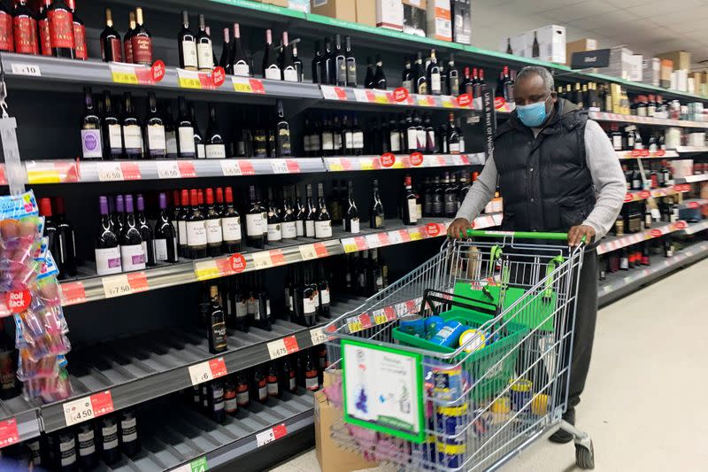 A shopper wears a mask at a supermarket in London