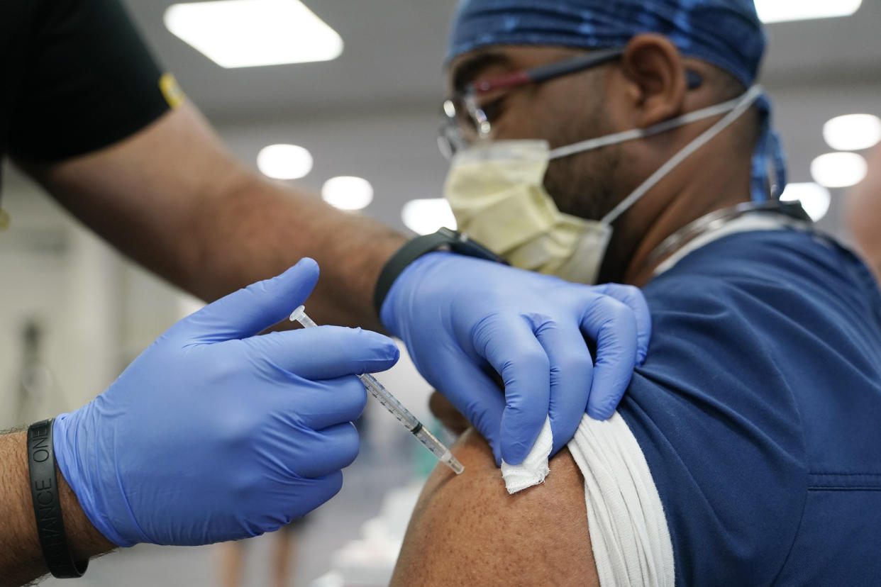 A healthcare worker receives a Pfizer COVID-19 booster shot at Jackson Memorial Hospital in Miami. (Lynne Sladky/AP, File)