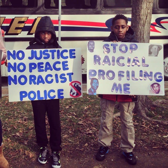 Young protesters hold signs in Freedom plaza on Saturday Dec. 13, 2014. 