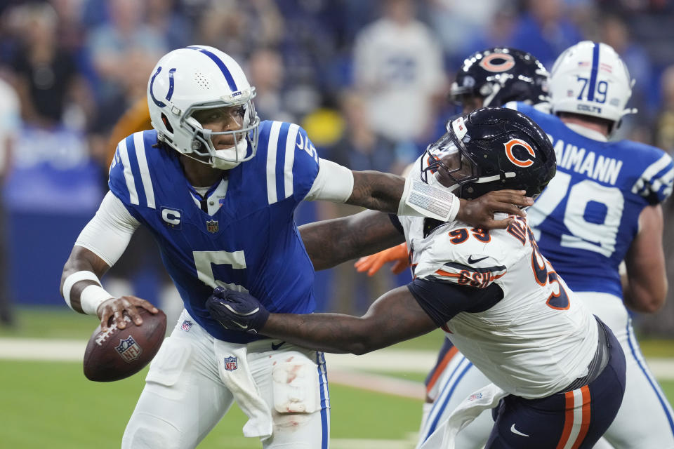 Indianapolis Colts quarterback Anthony Richardson (5) is pressured by Chicago Bears defensive tackle Gervon Dexter Sr. (99) during the first half of an NFL football game Sunday, Sept. 22, 2024, in Indianapolis. (AP Photo/Darron Cummings)