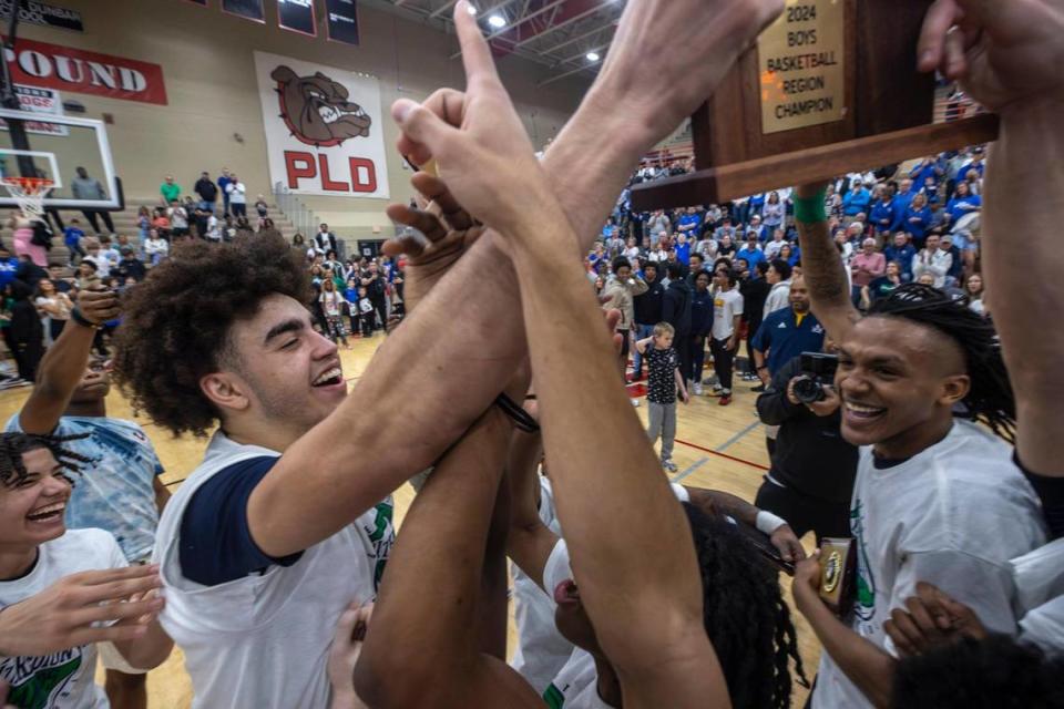 Great Crossing players, including Malachi Moreno, left and Jeremiah Godfrey, right, celebrate after winning the 11th Region Tournament championship game last week. The Warhawks are making their first appearance in the Sweet 16 this week.