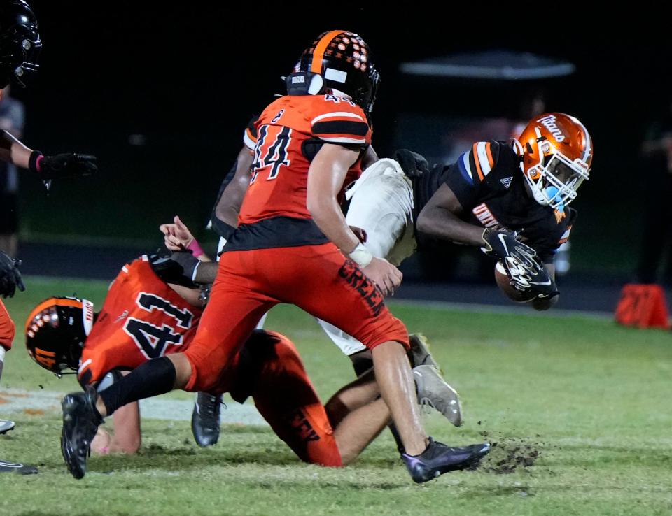 University's Demontay Johnson dives for extra yardage during a game with Spruce Creek at University High School in Orange City, Friday, Oct. 13, 2023.