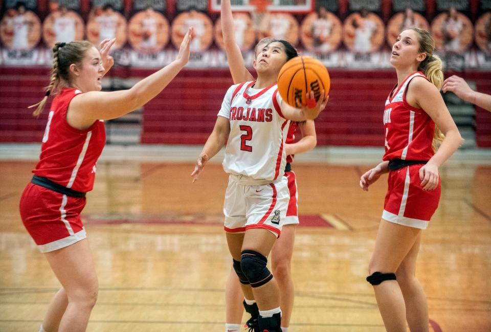 Lincoln's Riley Baquiran, center, drives to the hoop on Lodi's Zoe Aitken left, an Norah Mayer during a girls varsity basketball game at Lincoln High in Stockton on Jan. 25, 2024.