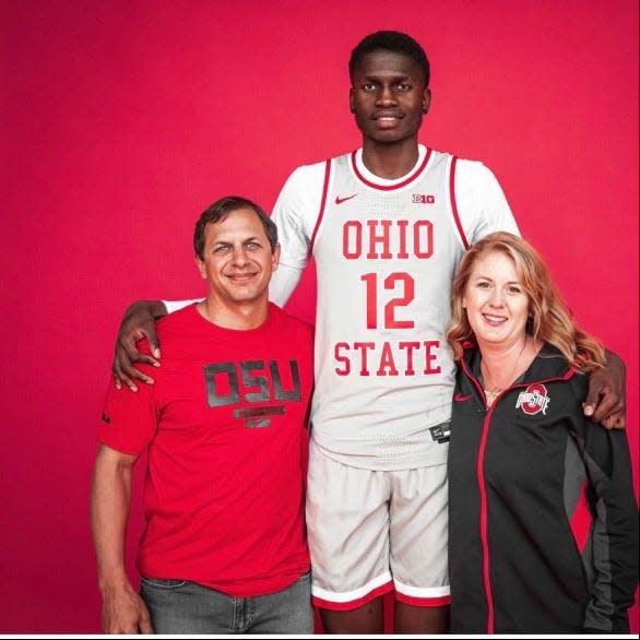 Ohio State's Felix Okpara poses with adopted parents Adam and Brittany Levitt while on an official visit as a recruit.