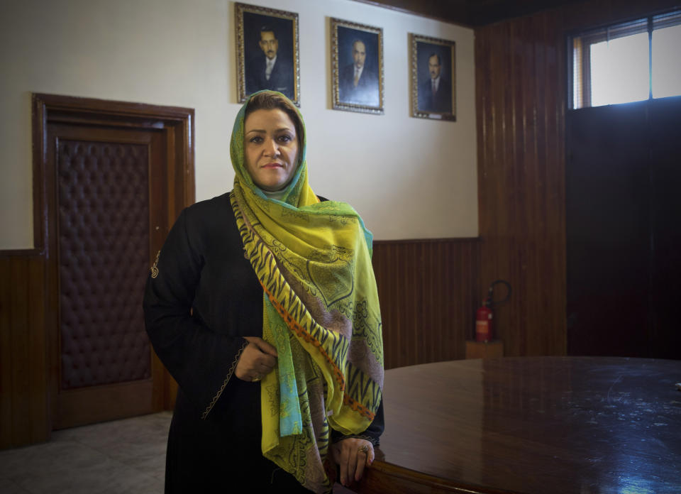 In this Wednesday, March 26, 2014 photo, Afghan lawmaker Dr. Farishda Amini from Nimroz poses in the entrance hall of the Afghan parliament in Kabul, Afghanistan. In the last elections in 2010, 69 women won seats in Afghanistan’s 249-seat parliament. The next parliamentary vote will be held in 2015, but first are the April 5 presidential and provincial council elections. (AP Photo/Anja Niedringhaus)