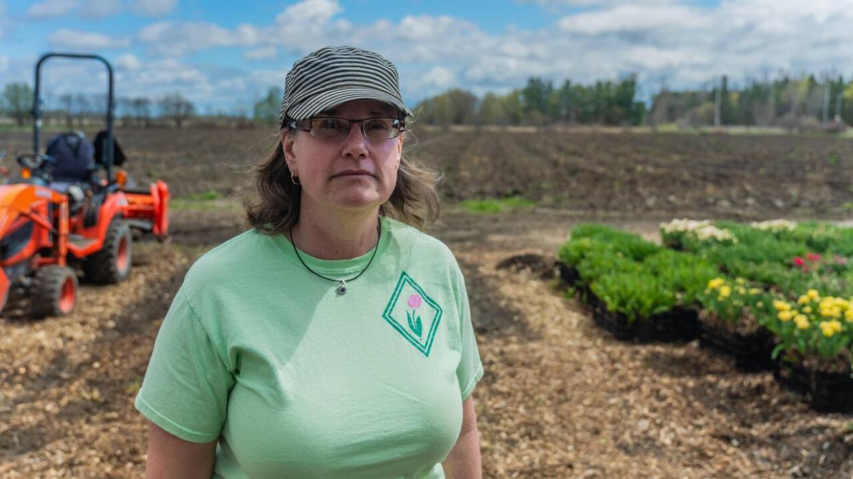 Manja Bastian stands in her barren tulip field after losing 500,000 tulips to a fungal disease called tulip fire.  (Michel Aspirot/CBC - image credit)