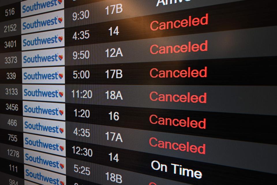 Travelers should review their options before flights are delayed or canceled. File photo: A digital display shows canceled flights in the Southwest Airlines luggage area, on Dec. 28, 2022, at Los Angeles International Airport. The perfect storm of fierce snow squalls, howling wind and sub-zero temperatures forced the cancellation of thousands of flights then.