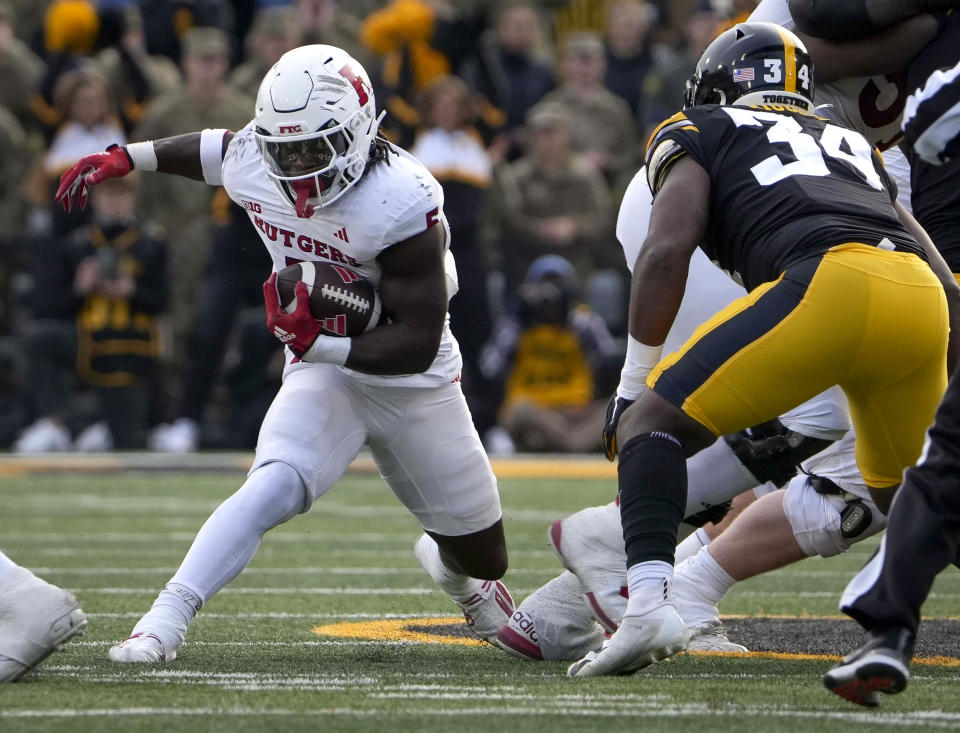 Rutgers running back Kyle Monangai (5) runs the ball against Iowa during the first half of an NCAA college football game, Saturday, Nov. 11, 2023, in Iowa City, Iowa. (AP Photo/Bryon Houlgrave)