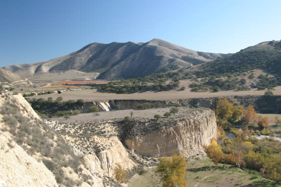 The broad bench in this photo marks an abandoned riverbed in the Arroyo Seco in California's Coast Ranges. The river has since incised a narrow gorge into the bench.