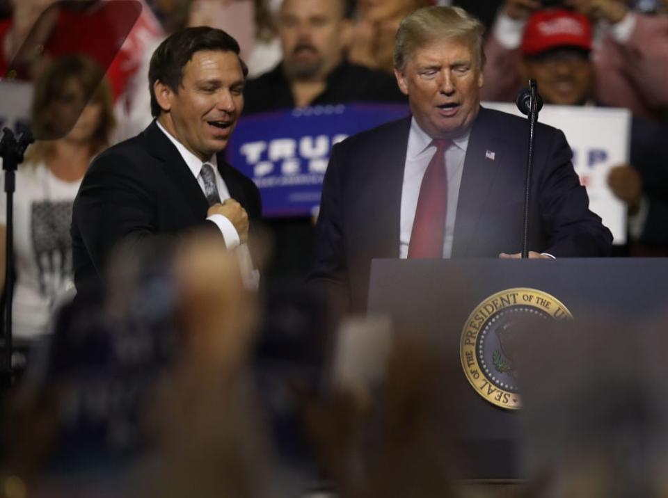 President Donald Trump stands with GOP Florida gubernatorial candidate Ron DeSantis during the president’s Make America Great Again Rally at the Florida State Fair Grounds Expo Hall on July 31, 2018, in Tampa, Florida. (Photo by Joe Raedle/Getty Images)
