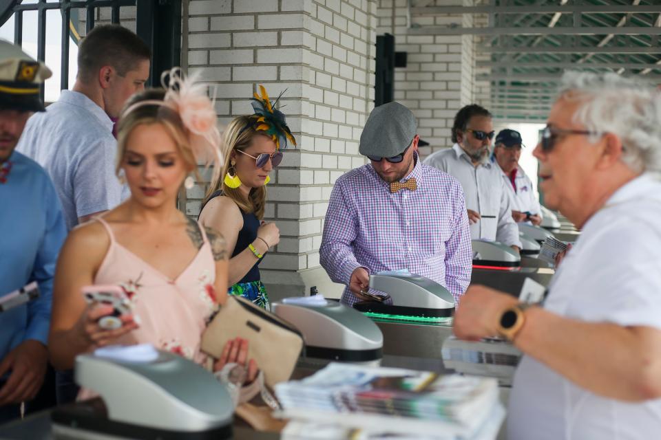 Attendees scan tickets at the gate before the start of races during Thurby at Churchill Downs in Louisville, Ky. on Thursday, May 2, 2019. 