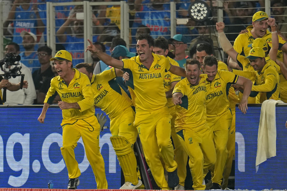 Australia's captain Pat Cummins, center, and teammates run to celebrate after their win in the ICC Men's Cricket World Cup final match against India in Ahmedabad, India, Sunday, Nov. 19, 2023. (AP Photo/Aijaz Rahi)