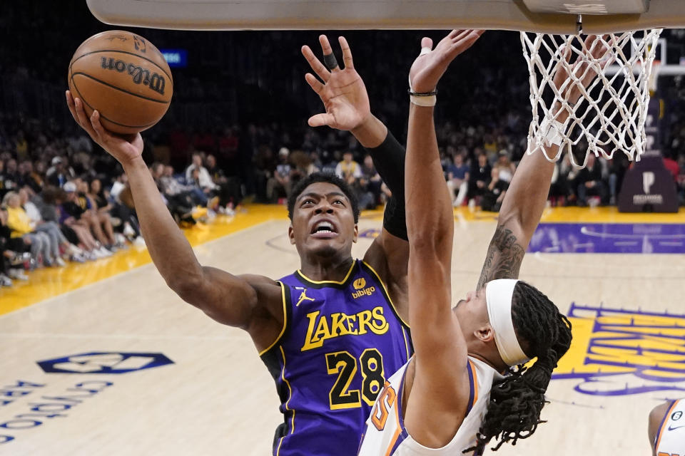 Los Angeles Lakers forward Rui Hachimura, left, shoots as Phoenix Suns guard Damion Lee defends during the first half of an NBA basketball game Friday, April 7, 2023, in Los Angeles. (AP Photo/Mark J. Terrill)