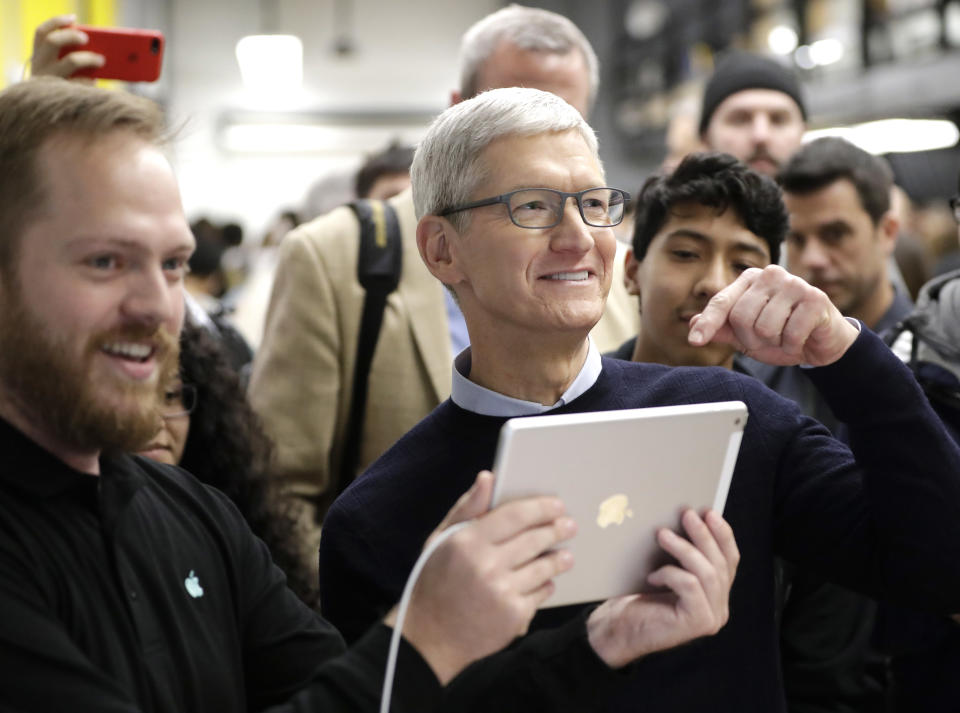 Apple CEO Tim Cook tells reporters they should see what is on the new iPad 9.7-inch screen at an Apple educational event at Lane Technical College Prep High School Tuesday, March 27, 2018, in Chicago. Apple will report earnings after the market close on Tuesday. (AP Photo/Charles Rex Arbogast)