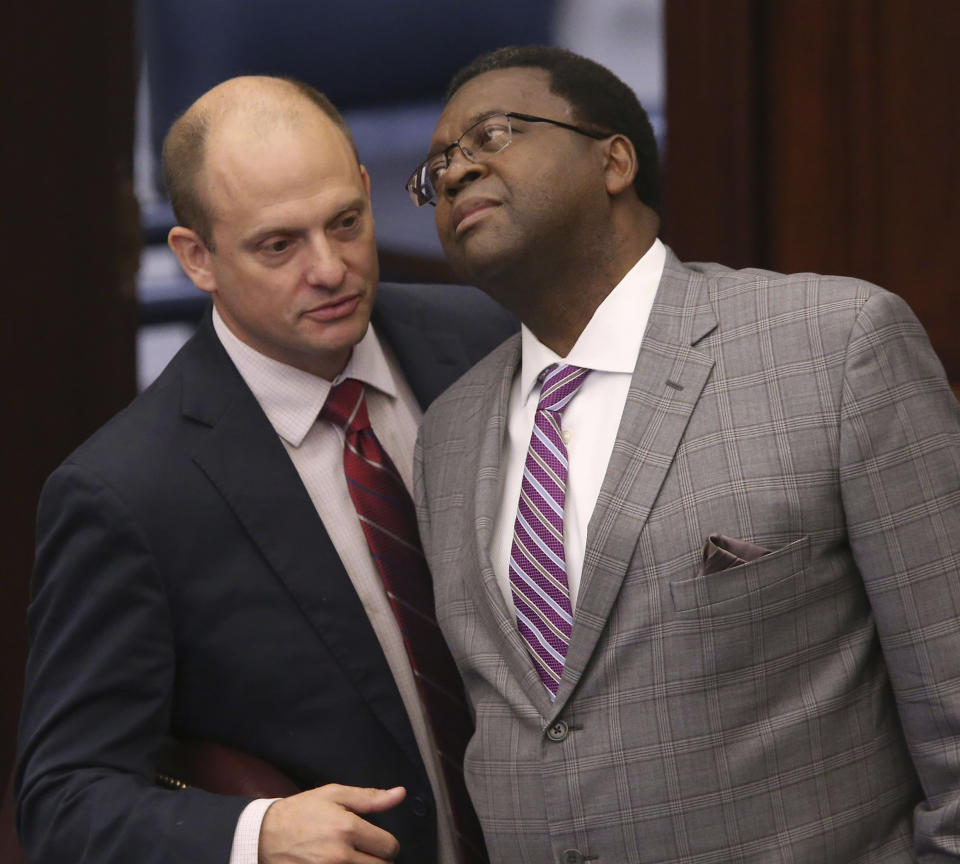 Sen. Jose Rodriguez, D-Miami, left, confers with Sen. Perry Thurston during a legislative session Wednesday April 17, 2019, in Tallahassee, Fla. (AP Photo/Steve Cannon)