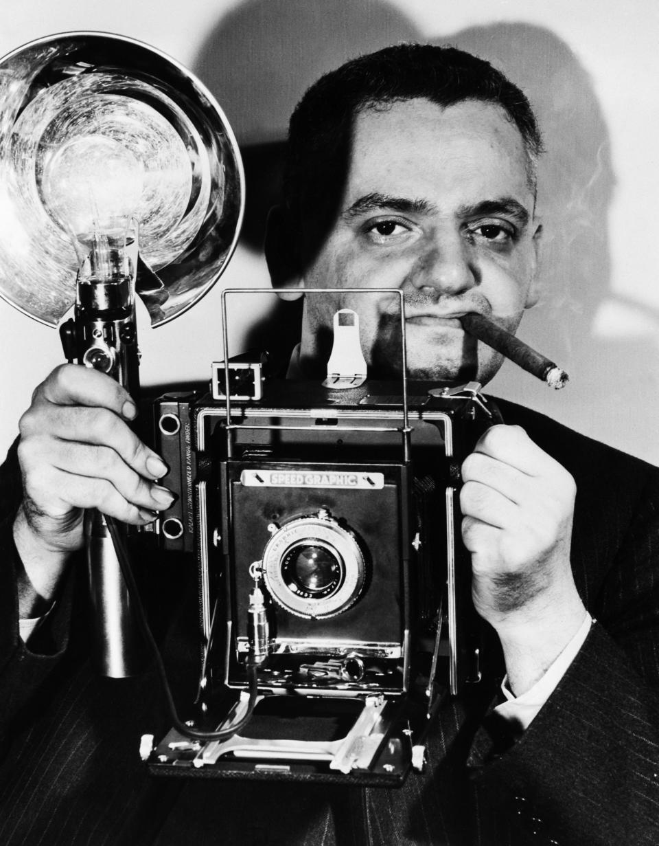 Weegee with his Speed Graphic camera, 1945. 