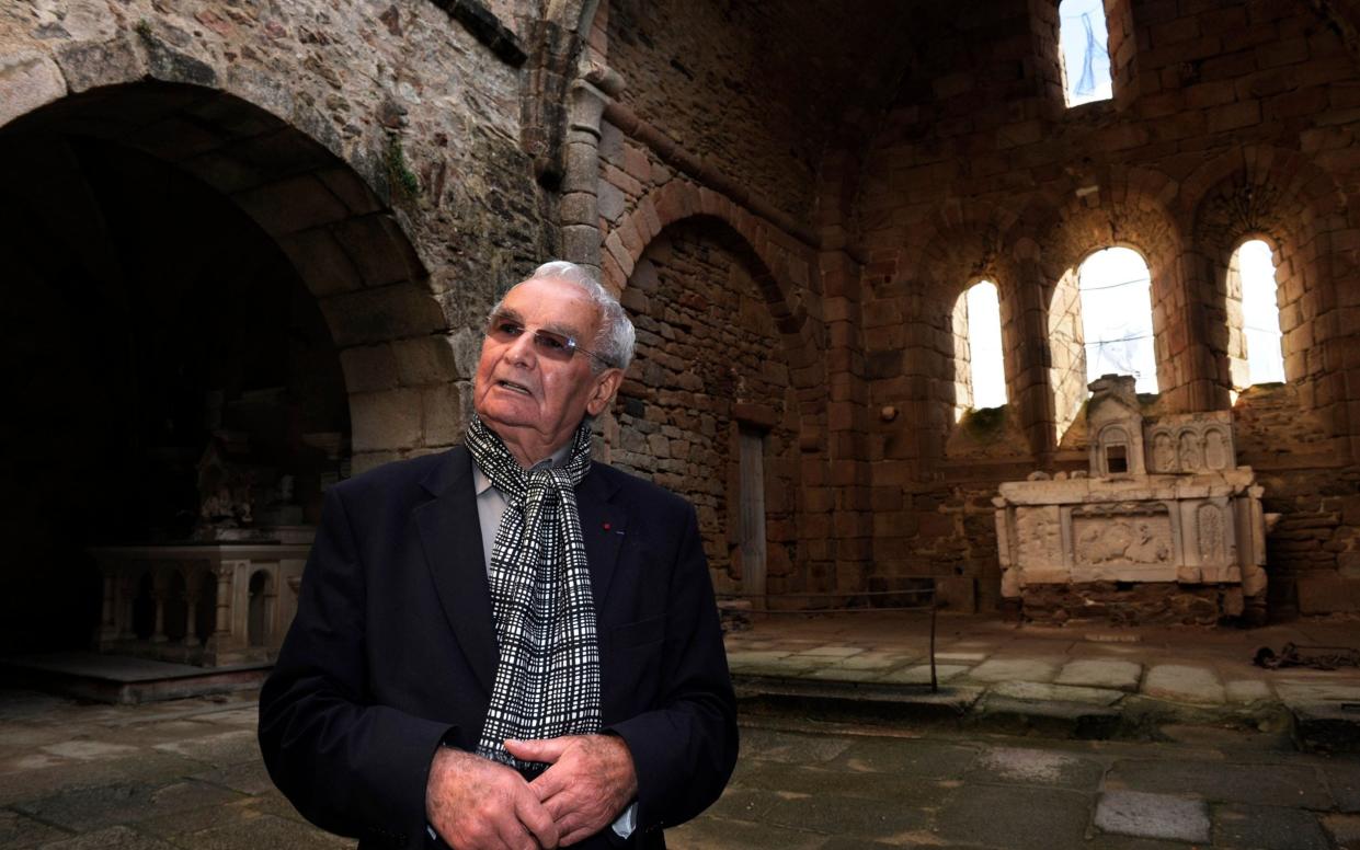 Robert Hébras in the ruins of the church at Oradour where around 450 women and children were suffocated or burnt to death - JEAN-PIERRE MULLER/AFP via Getty Images