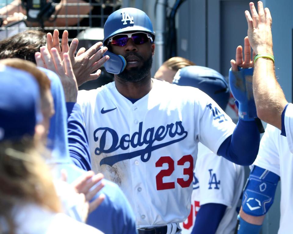 Dodgers right fielder Jason Heyward gets high-fives from teammates.