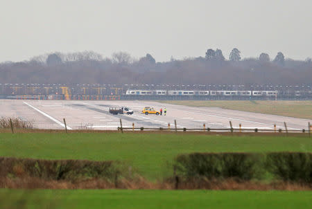 Airport vehicles stand on the closed runway at Gatwick Airport after drones flying illegally over the airfield forced the closure of the airport, in Gatwick, Britain, December 20, 2018. REUTERS/Peter Nicholls