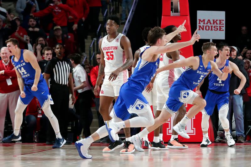 Houston center Brison Gresham (55) leaves the court as BYU players celebrate a 72-71 win during an NCAA college basketball game Friday, Nov. 15, 2019, in Houston. | Michael Wyke/Houston Chronicle via AP