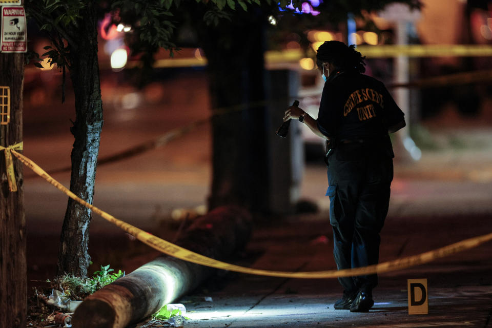 Police investigate the scene of a shooting Monday, July 3, 2023 in Philadelphia. Police say a gunman in a bulletproof vest has opened fire on the streets of Philadelphia, killing several people and wounding two boys before he surrendered to responding officers. (Steven M. Falk/The Philadelphia Inquirer via AP)