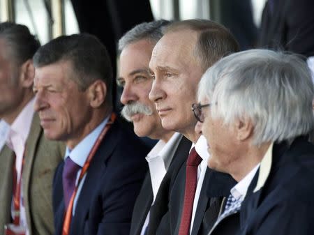 Formula One - F1 - Russian Grand Prix - Sochi, Russia - 30/04/17 - (R-L) Former Chief Executive of the Formula One Group Bernie Ecclestone, Russian President Vladimir Putin and F1 chairman Chase Carey watch the race. Sputnik/Alexei Nikolsky/Kremlin via REUTERS