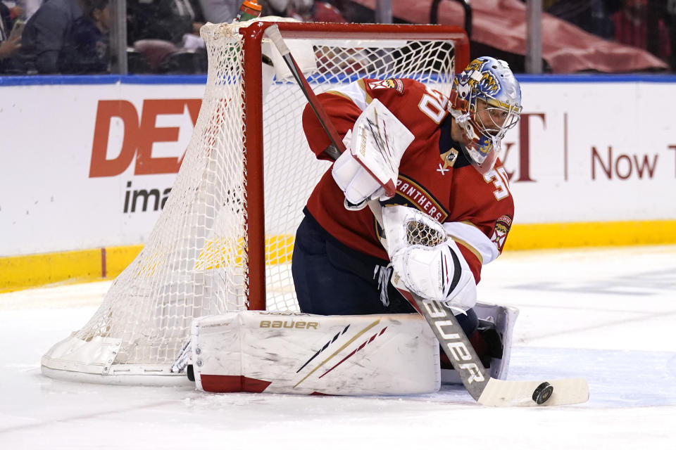 Florida Panthers goaltender Spencer Knight (30) stops a shot on the goal during the first period in Game 5 of an NHL hockey Stanley Cup first-round playoff series against the Tampa Bay Lightning, Monday, May 24, 2021, in Sunrise, Fla. (AP Photo/Lynne Sladky)