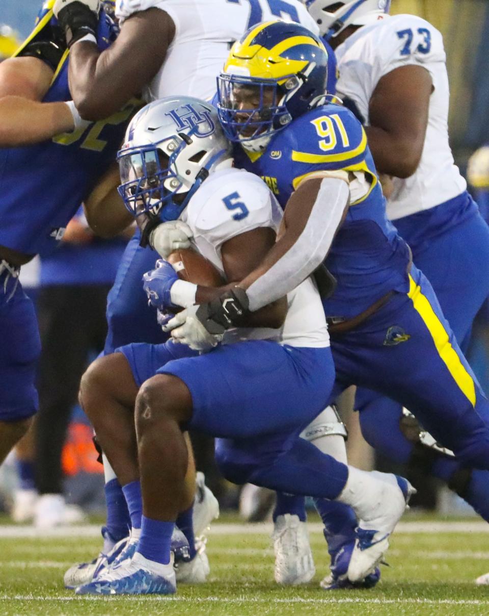 Delaware's Artis Hemmingway pulls down Hampton runner Elijah Burris in the second quarter of the Blue Hens' 35-3 win at Delaware Stadium, Saturday, Sept. 24, 2022.