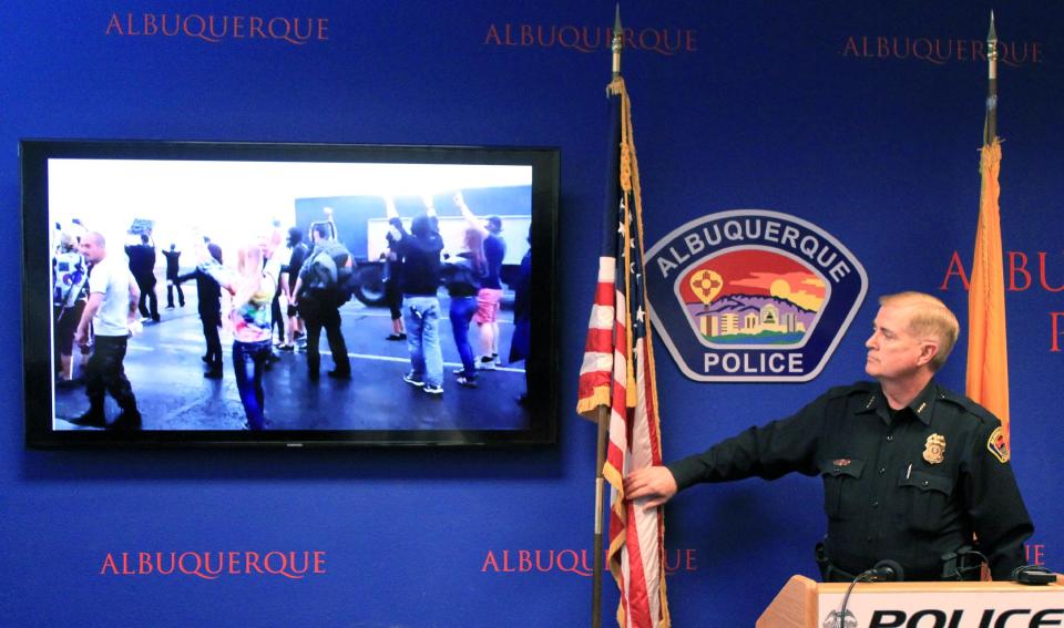 Albuquerque Police Chief Gorden Eden shows video and photographs from an hours' long protest over police shootings during a news conference in Albuquerque, N.M. on Monday, March 31, 2014. (AP Photo/Susan Montoya Bryan)