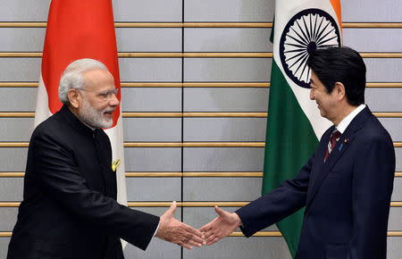 Indian Prime Minister Narendra Modi (L) is greeted by Japan's Prime Minister Shinzo Abe at the start of their meeting at Abe's official residence in Tokyo, Japan November 11, 2016. REUTERS/Franck Robichon/Pool