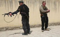 Foreign security guards stand near the main gate of Cure International Hospital in Kabul, Afghanistan, Thursday, April 24, 2014. The U.S. embassy in Afghanistan says three American doctors have been killed at by an Afghan security guard who opened fire at a hospital in Kabul. The shooting at Cure International Hospital in western Kabul was the latest attack on foreign civilians in the Afghan capital this year. (AP Photo/Massoud Hossaini)