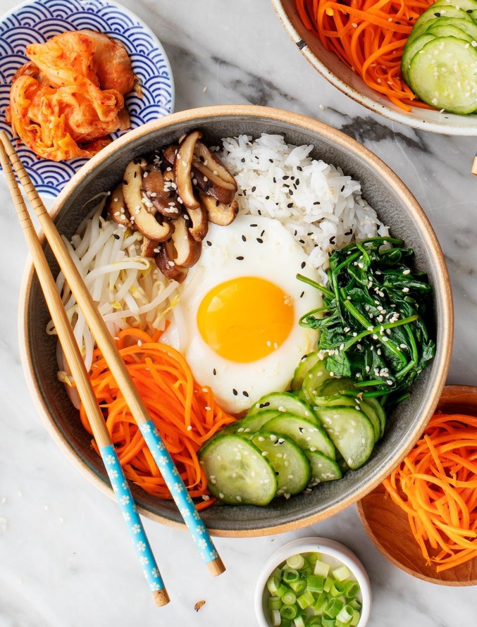 A bowl of veggie bibimbap with a fried egg